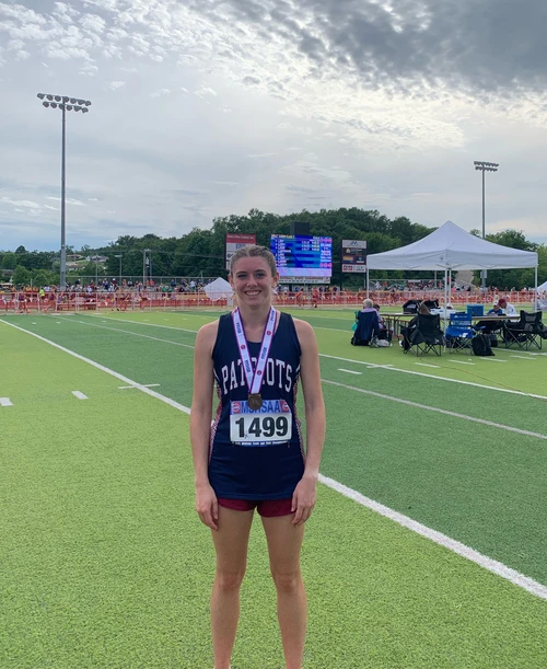 Girl smiling with medal.